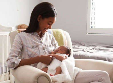 Young black mother holding her newborn.